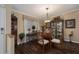 Bright dining area with glass table and dark hardwood floors at 8414 Imperial Cir, Palmetto, FL 34221