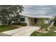 Front view of manufactured home with driveway and landscaping at 8414 Imperial Cir, Palmetto, FL 34221