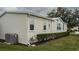 House exterior showcasing light beige vinyl siding and landscaping at 8414 Imperial Cir, Palmetto, FL 34221