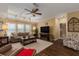 Living room with hardwood floors, TV, and ample seating at 8414 Imperial Cir, Palmetto, FL 34221