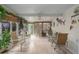 Bright sunroom with tiled floor, wicker furniture, and ceiling fan at 8414 Imperial Cir, Palmetto, FL 34221