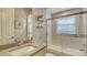 Small bathroom with a tub shower combo and updated vanity at 8994 Wildlife Loop, Sarasota, FL 34238