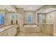 Spa-like bathroom with soaking tub and walk-in shower at 8994 Wildlife Loop, Sarasota, FL 34238