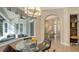 Casual breakfast nook with glass table and chairs, adjacent to kitchen and living room at 8994 Wildlife Loop, Sarasota, FL 34238