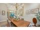 Modern dining room with a long wooden table and neutral color palette at 8994 Wildlife Loop, Sarasota, FL 34238