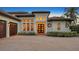 Home exterior featuring a three-car garage and a brick paver driveway at 8994 Wildlife Loop, Sarasota, FL 34238