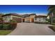 Two-story house with brown roof and brick driveway at 8994 Wildlife Loop, Sarasota, FL 34238