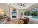 Gathering room with fireplace, pool view, and access to outdoor patio at 8994 Wildlife Loop, Sarasota, FL 34238