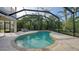 Relaxing kidney shaped pool with screened enclosure and patio furniture at 8994 Wildlife Loop, Sarasota, FL 34238