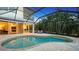 Resort-style pool and patio with covered lanai at 8994 Wildlife Loop, Sarasota, FL 34238