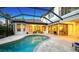 Luxury pool and patio with covered patio and lounge chairs at 8994 Wildlife Loop, Sarasota, FL 34238