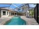 Relaxing kidney shaped pool with screened enclosure and patio furniture at 8994 Wildlife Loop, Sarasota, FL 34238