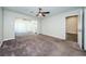 Main bedroom with carpet, ceiling fan and access to private bathroom and patio at 1003 Lake Avoca Dr, Tarpon Springs, FL 34689