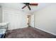 Bedroom with ceiling fan, carpeting, and mirrored closet doors at 1003 Lake Avoca Dr, Tarpon Springs, FL 34689