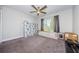 Spacious bedroom with ceiling fan and carpeting at 1003 Lake Avoca Dr, Tarpon Springs, FL 34689