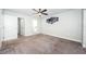 Large bedroom with carpet, ceiling fan, and access to bathroom and closet at 1003 Lake Avoca Dr, Tarpon Springs, FL 34689