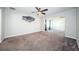 Spacious bedroom with ceiling fan and carpeting at 1003 Lake Avoca Dr, Tarpon Springs, FL 34689