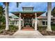 Community clubhouse entrance with covered walkway and seating at 1003 Lake Avoca Dr, Tarpon Springs, FL 34689