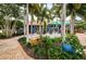 Outdoor seating area with tables and lush landscaping at 1003 Lake Avoca Dr, Tarpon Springs, FL 34689