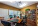 Meeting room with large table, chairs, and extensive book collection at 1003 Lake Avoca Dr, Tarpon Springs, FL 34689