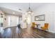 Elegant dining room with chandelier and view into kitchen at 1003 Lake Avoca Dr, Tarpon Springs, FL 34689