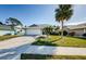 House exterior showcasing a white garage door and green lawn at 1003 Lake Avoca Dr, Tarpon Springs, FL 34689