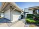 House exterior with white garage door and walkway at 1003 Lake Avoca Dr, Tarpon Springs, FL 34689