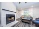 Living room with modern fireplace and cozy seating area at 1003 Lake Avoca Dr, Tarpon Springs, FL 34689