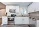 Modern kitchen with stainless steel appliances and white cabinets at 1003 Lake Avoca Dr, Tarpon Springs, FL 34689