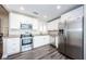 Modern kitchen with stainless steel appliances and white cabinets at 1003 Lake Avoca Dr, Tarpon Springs, FL 34689