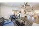 Living room with wood-look floors, fireplace, and ceiling fan at 1003 Lake Avoca Dr, Tarpon Springs, FL 34689