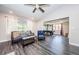 Bright living room with pool table, comfy seating, and wood-look floors at 1003 Lake Avoca Dr, Tarpon Springs, FL 34689