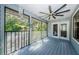 Relaxing screened porch with ceiling fan and wood flooring at 1003 Lake Avoca Dr, Tarpon Springs, FL 34689