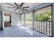 Spacious screened porch with ceiling fan and access to backyard at 1003 Lake Avoca Dr, Tarpon Springs, FL 34689