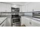 Well-equipped kitchen with stainless steel appliances and white cabinets at 101 S Gulfstream Ave # 12C, Sarasota, FL 34236