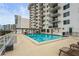 Community pool with surrounding lounge chairs at 101 S Gulfstream Ave # 12C, Sarasota, FL 34236