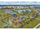 Aerial view of community amenities, including a pool, playground, and lush landscaping at 10328 Charlotte Dr, Parrish, FL 34219