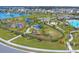 Aerial view showing a playground, pool, and surrounding neighborhood at 10328 Charlotte Dr, Parrish, FL 34219