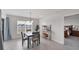 Bright dining area with a table and chairs, looking toward bedroom at 10328 Charlotte Dr, Parrish, FL 34219