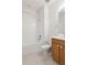 Clean bathroom with a tub, toilet and wood vanity at 10531 Piedra Dr, Palmetto, FL 34221