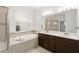 Double vanity bathroom with a soaking tub and shower at 10531 Piedra Dr, Palmetto, FL 34221