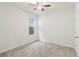 Bright bedroom with ceiling fan and neutral carpeting at 10531 Piedra Dr, Palmetto, FL 34221