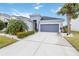 Single-story house with gray siding, palm trees, and driveway at 10531 Piedra Dr, Palmetto, FL 34221