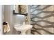 Stylish bathroom with patterned wall and pedestal sink at 111 S Pineapple Ave # 1006, Sarasota, FL 34236