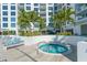 Relaxing hot tub surrounded by palm trees and lounge chairs at 111 S Pineapple Ave # 1006, Sarasota, FL 34236