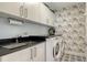 Laundry room with washer, dryer, and ample storage at 111 S Pineapple Ave # 1006, Sarasota, FL 34236