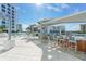 Outdoor seating area with bar and lounge chairs near the pool at 111 S Pineapple Ave # 1006, Sarasota, FL 34236