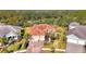 Bird's-eye view of a house nestled in a community with mature trees and other homes at 12654 Harney St, Venice, FL 34293