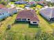 Aerial view of house showcasing a large backyard and a Spanish-style tile roof at 12654 Harney St, Venice, FL 34293