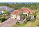 Tan house with tile roof, three car garage and palm trees at 12654 Harney St, Venice, FL 34293